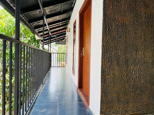 an empty hallway of a house with a fence at 3Empire Room with Common Pool in Wayanad
