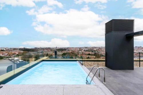 a swimming pool on the roof of a house at New Douro 908 with parking in Vila Nova de Gaia