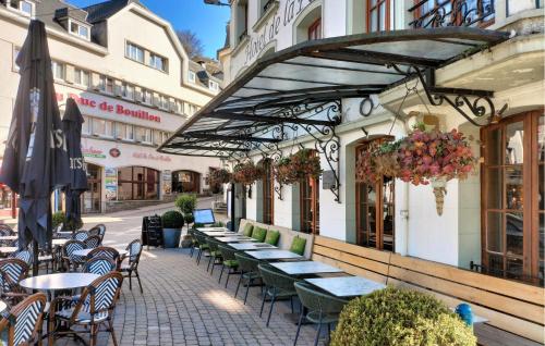 a row of tables and chairs outside of a building at Beautiful Apartment In Bouillon in Bouillon