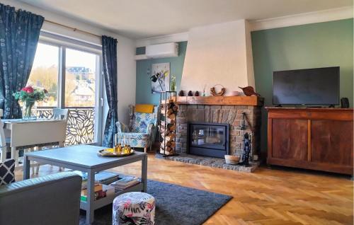 a living room with a fireplace and a tv at Beautiful Apartment In Bouillon in Bouillon