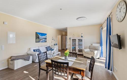 a dining room and living room with a table and chairs at Maritim 2 in Gransee