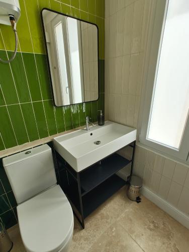 a bathroom with a toilet and a sink and a mirror at Alba in Sliema