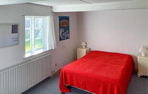 a bedroom with a red bed and a window at Cozy Home In Horslunde With Wifi in Horslunde