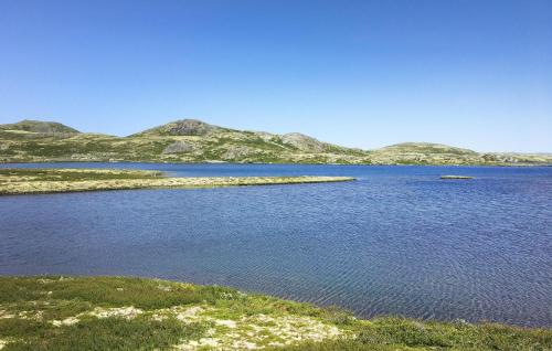 a large body of water with mountains in the background at Beautiful Home In Nesbyen With Sauna in Nesbyen