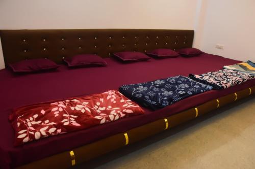 a large bed with pillows on it in a room at Devansh Homestay in Ujjain