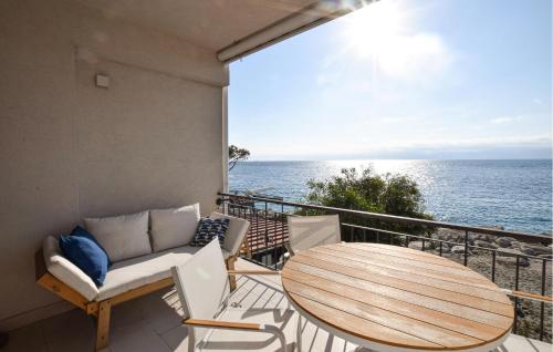 a balcony with a table and chairs and the ocean at Awesome Apartment In Reggio Calabria in Reggio Calabria