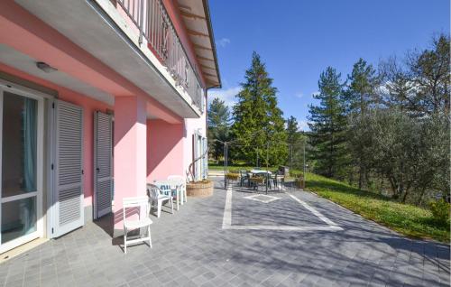 a patio with a table and chairs next to a building at Awesome Home In Capolona in Capolona