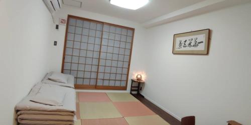 a room with a bed and a sliding door at Kyoto Guesthouse Rantan - Vacation STAY 84810v in Nishi-kujō-Toriiguchichō