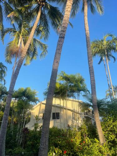 a building with palm trees in front of it at Beach Comber in Port Douglas