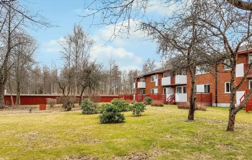 an apartment building with a yard in front of it at Gorgeous Apartment In Hyltebruk in Hyltebruk