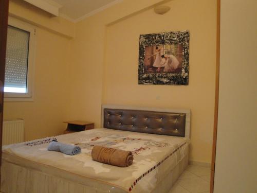 a bed in a bedroom with a picture on the wall at Central Kalli Ap in Kallithea Halkidikis