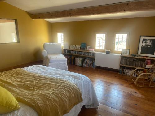 a bedroom with a bed and a book shelf at bastide Uzes à pied Piscine vue imprenable Havre de paix in Uzès