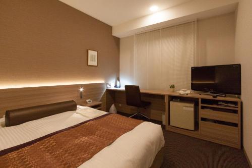 
A bed or beds in a room at Ueda Tokyu REI Hotel
