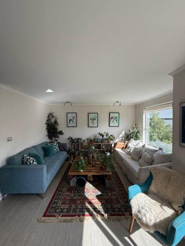 a living room with two couches and a coffee table at Cómoda Habitación Punta Arenas in Punta Arenas