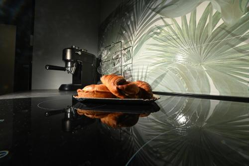 a plate of croissants on a glass table at The Place in Cutrofiano