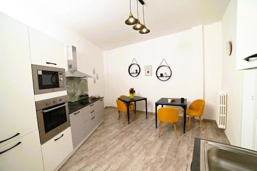 a kitchen and dining room with a table and chairs at The Place in Cutrofiano