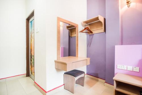 a dressing room with a mirror and a stool at Valley View Hotel in Lumut