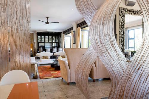 a living room with a large mirror in the middle at Marion Views in Ballito