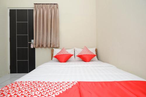 Ένα ή περισσότερα κρεβάτια σε δωμάτιο στο Hotel O Unta Residence