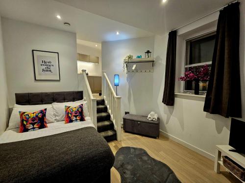 a bedroom with a bed and a stair case at Lennon Place in Liverpool