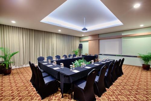 a conference room with a long table and chairs at The Alana Surabaya in Surabaya