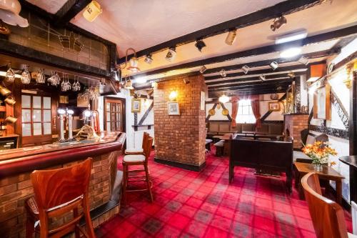 a pub with a bar with a red carpet at OYO The Royal Hotel in Newcastle upon Tyne