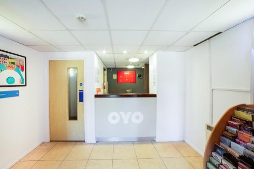 an empty hallway in a hospital with an oo sign on the wall at OYO Sunrise Hotel, A46 N Leicester in Thrussington