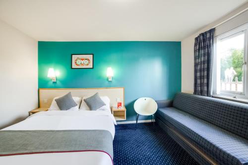 a hotel room with two beds and a window at OYO Sunrise Hotel, A46 N Leicester in Thrussington