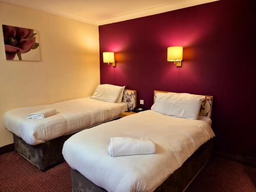 Ένα ή περισσότερα κρεβάτια σε δωμάτιο στο Supreme Inn Boston
