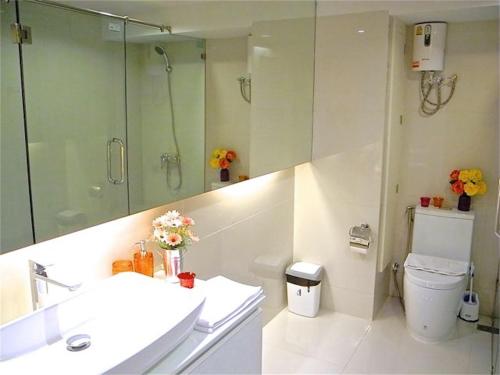 ein Bad mit einem Waschbecken, einer Dusche und einem WC in der Unterkunft Kata Plaza 1 bedroom Modern Apartment in Kata Beach