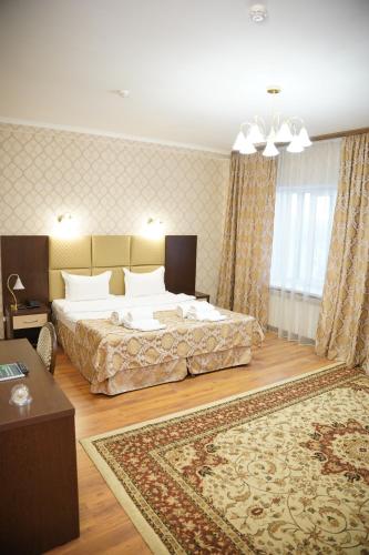 a bedroom with two beds and a rug at Sultan Beibarys in Astana