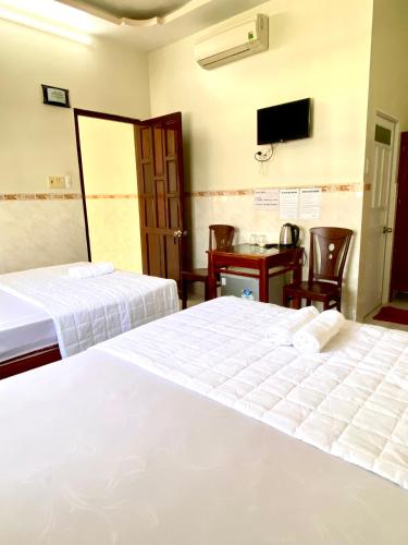 Postel nebo postele na pokoji v ubytování Thanh Trúc Guest House