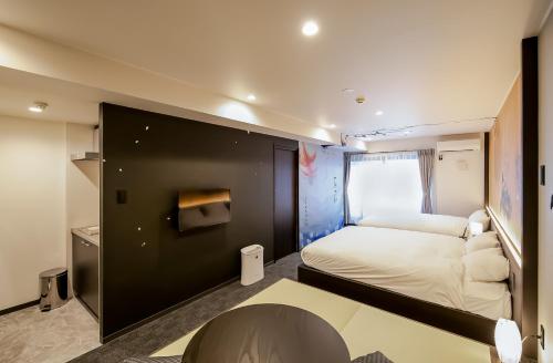 a small room with a bed and a window at Randor Residence Kyoto Nijo Castle in Kyoto