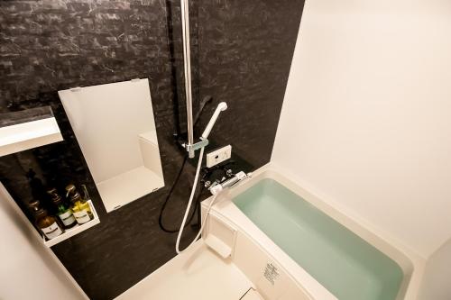 a bathroom with a sink and a bath tub at Randor Residence Kyoto Nijo Castle in Kyoto