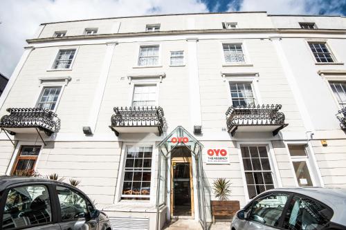 a white building with cars parked in front of it at The Regency, Clifton Bristol in Bristol