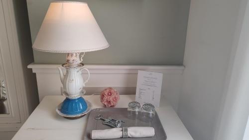 a lamp sitting on a table next to a sink at Dimora Bellini - Residenza d'Epoca in Palermo