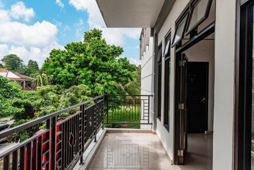 a balcony with a view of a tree at Hotel O Kambang Iwak Area Near Kambang Iwak Park Formerly Kerangga in Palembang