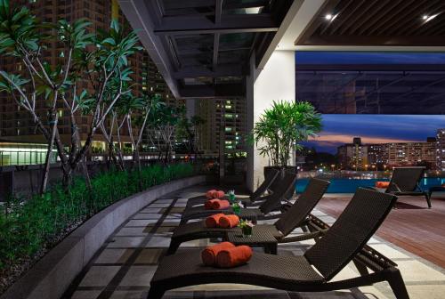 a rooftop patio with chairs and a table with pumpkins at VE Hotel & Residence in Kuala Lumpur