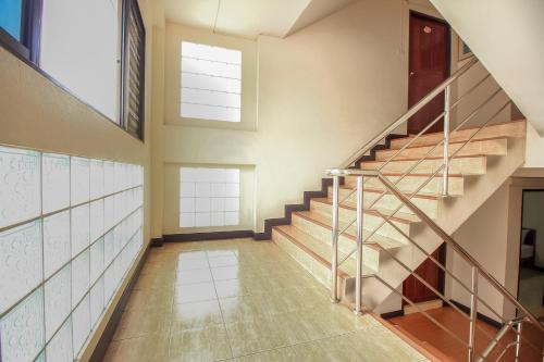an empty hallway with stairs in a house at Ok Home Airport in Bangkok