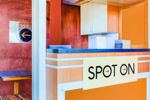 a restaurant counter with a sign that reads spion at Hotel O Family Residence in Kediri
