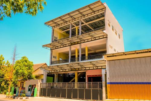 a building with balconies on the side of it at Hotel O Family Residence in Kediri