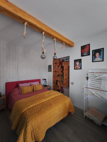 a bedroom with a large bed with a yellow blanket at Home Glos ter in Tarajalejo