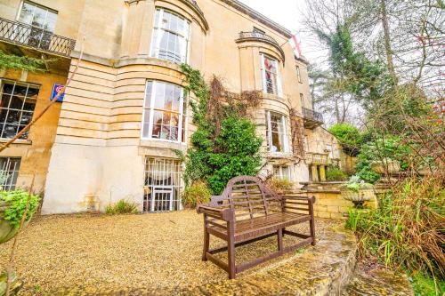 a bench sitting in front of a building at OYO Bailbrook Lodge, Bath in Bath