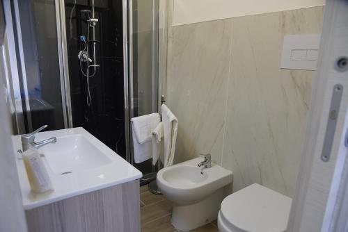 a bathroom with a sink and a toilet and a shower at Prestige Affittacamere Paestum in Stazione di Paestum