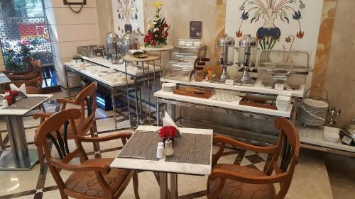 a restaurant with tables and chairs and a counter at Residency Hotel Fort in Mumbai