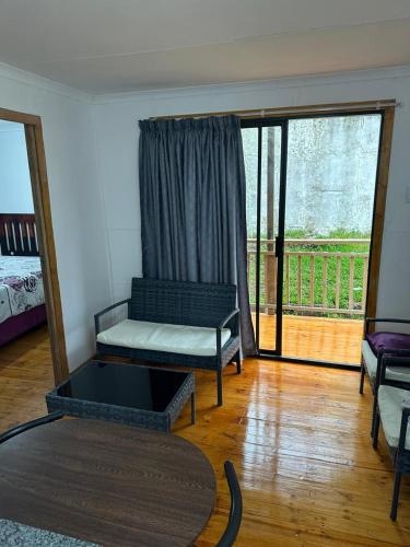 a living room with a couch and a table at Dream View Mountain Cabin 2 in Durban