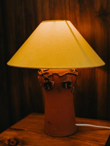 a lamp sitting on top of a wooden table at LA MER Homestay Quynhon in Quy Nhon