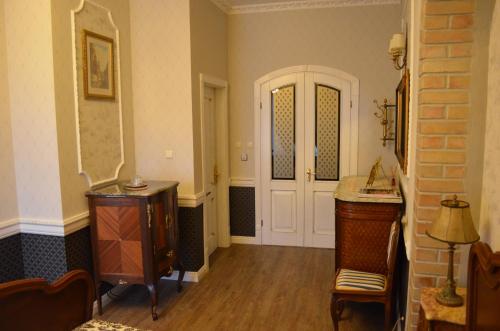 a room with a hallway with a door and a table at Gabi B&B in Vilnius