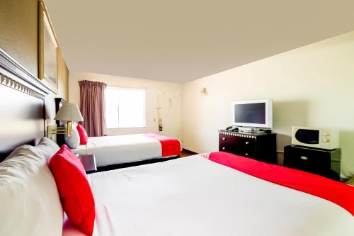 a hotel room with two beds and a television at OYO Hotel Eloy Casa Grande near I-10 in Eloy