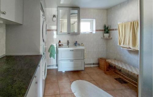 a white bathroom with a sink and a mirror at Amazing Home In Munka-Ljungby With Wifi in Munka-Ljungby